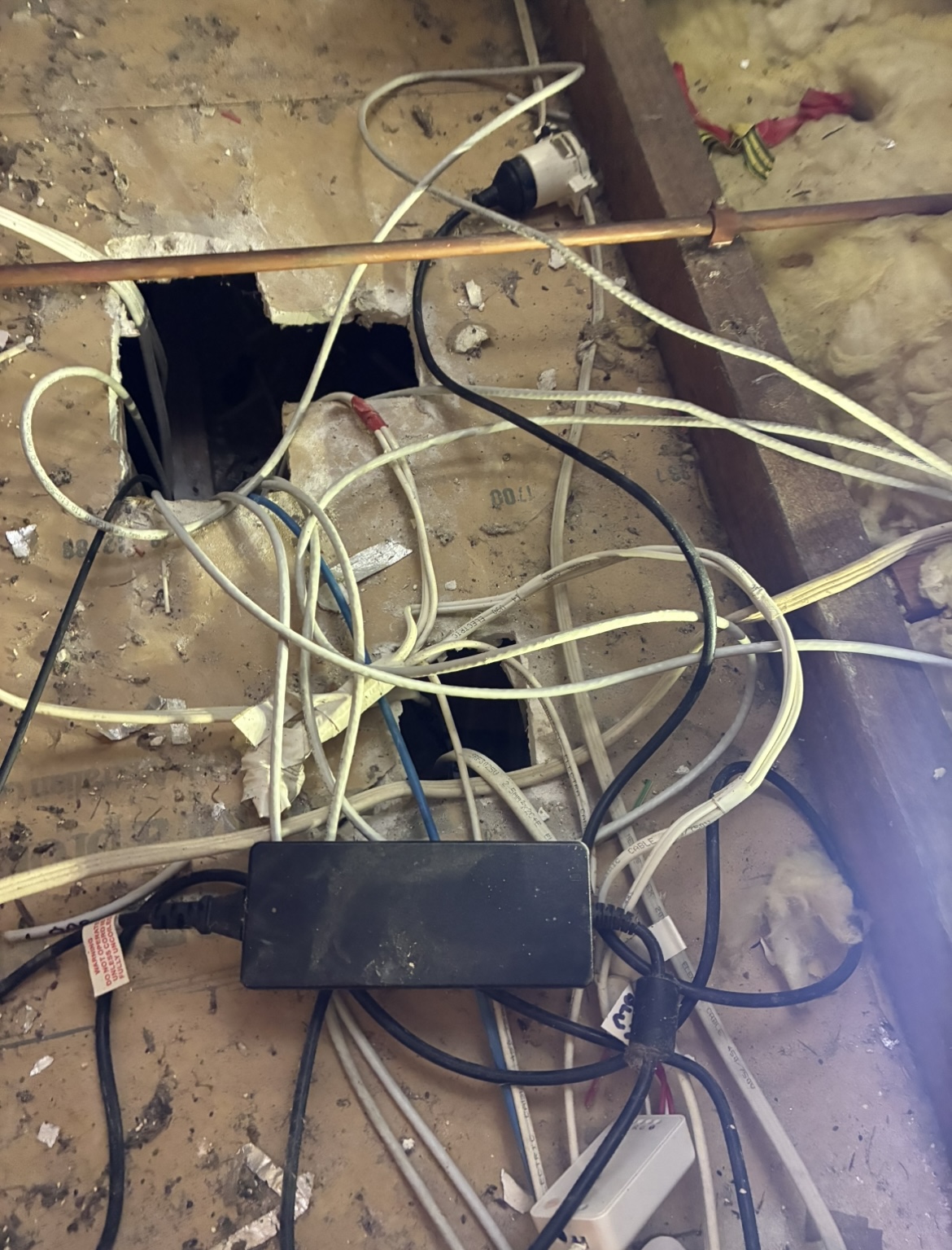 Old electrical wiring and junction box in roof space during home rewiring in Capalaba by Amplus Electrical and Air