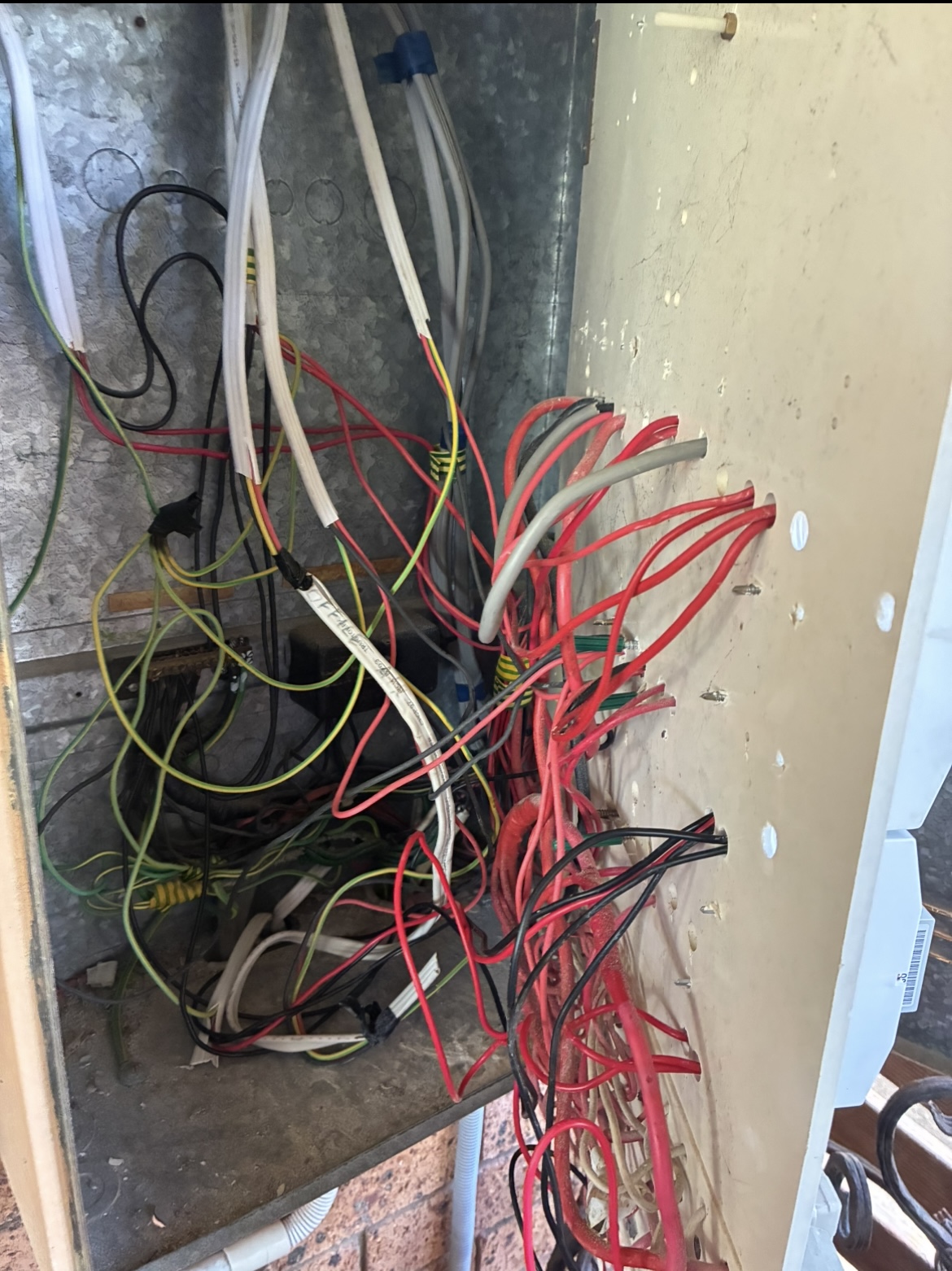 Switchboard rewiring in progress with new red and green cables — home rewiring Capalaba by Amplus Electrical and Air