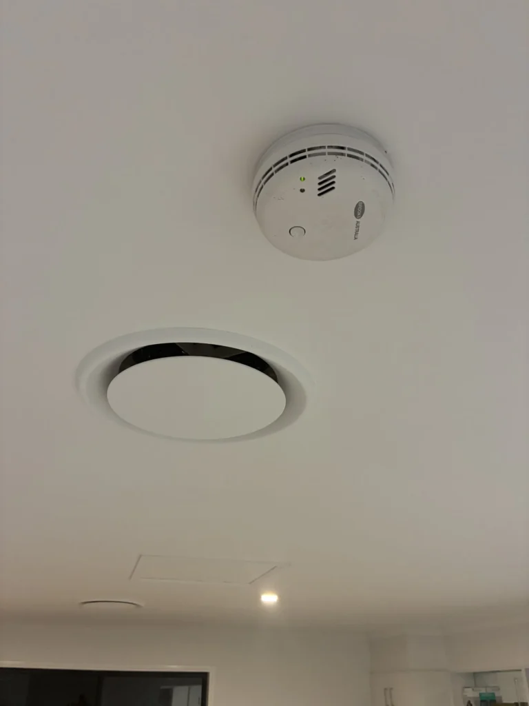 Photoelectric smoke alarm installed on ceiling by Amplus Electrical and Air — smoke alarm compliance Capalaba QLD
