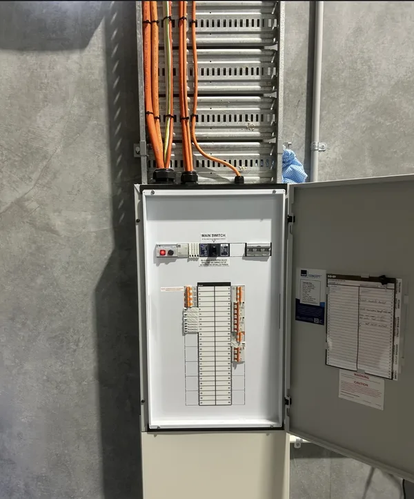 Commercial three-phase switchboard with orange cabling installed by Amplus Electrical and Air — commercial electrician Capalaba