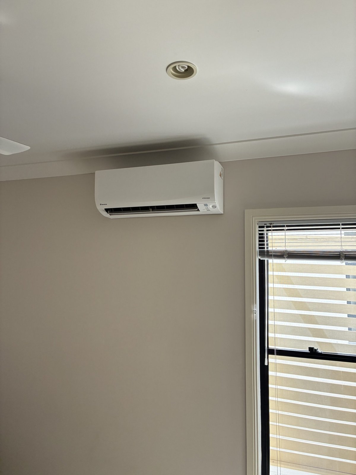 Daikin split system indoor unit installed in Alexandra Hills bedroom — Amplus Electrical and Air