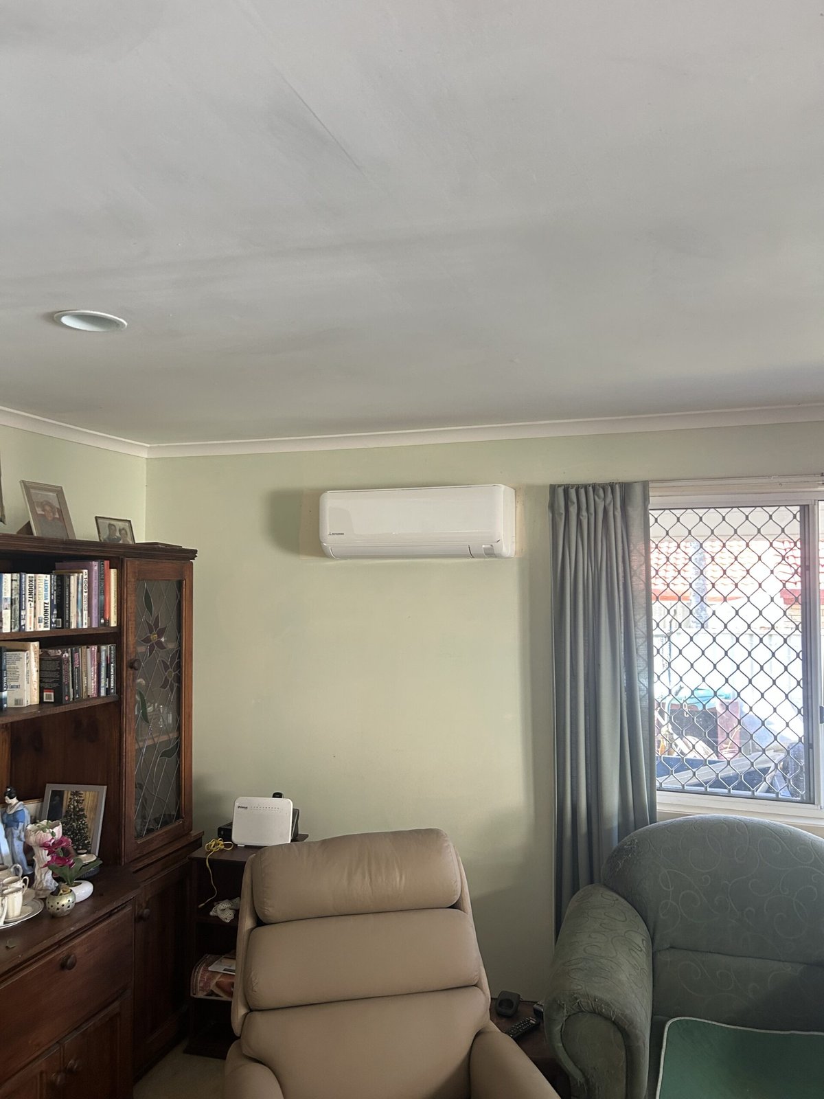 Mitsubishi split system wall-mounted indoor unit installed in living room — Alexandra Hills air conditioning by licensed electrician