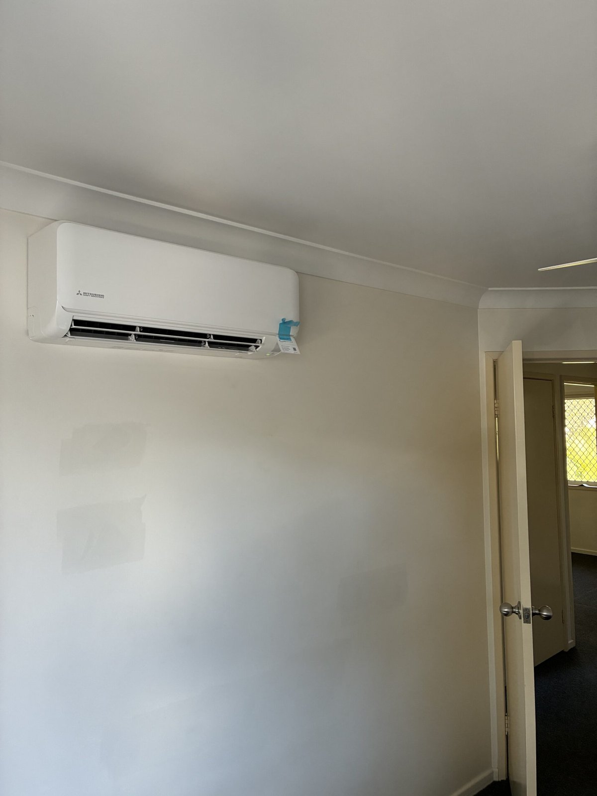 Split system installation in progress by Amplus Electrical and Air — serving Birkdale homeowners