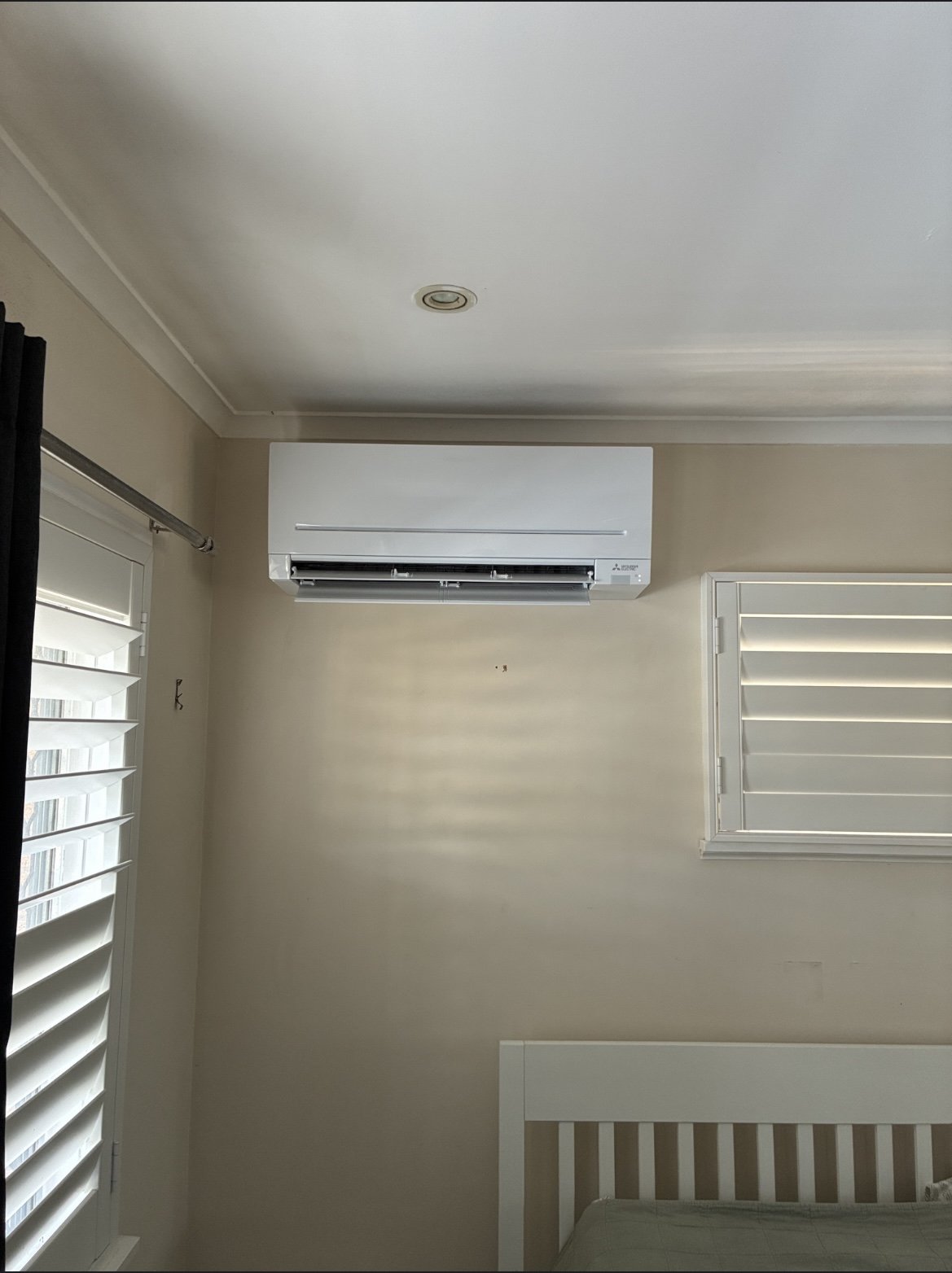 Split system outdoor unit installation in progress at Cleveland home — Amplus van on site