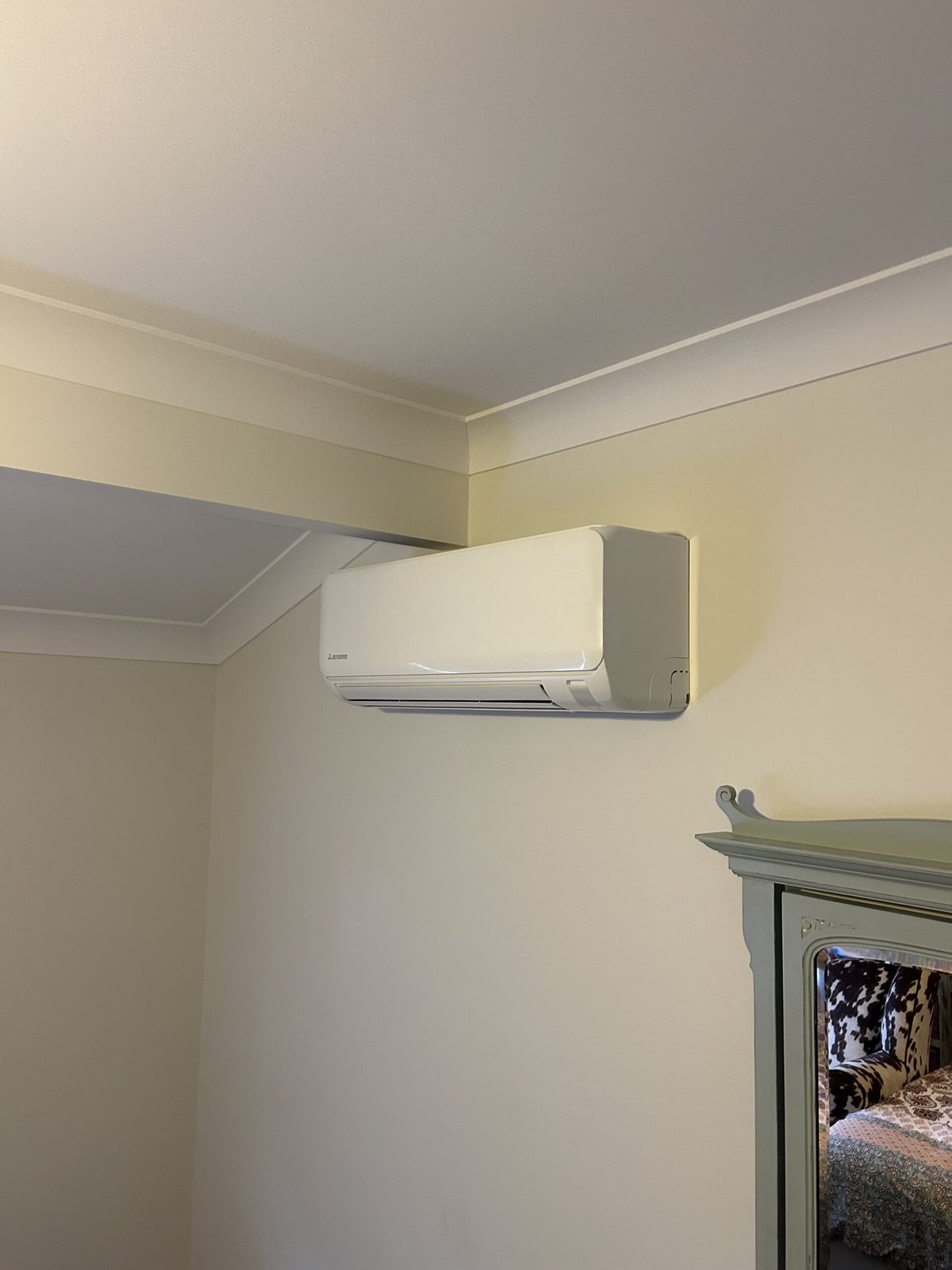 Aaron from Amplus installing a split system air conditioner at a Brisbane bayside home