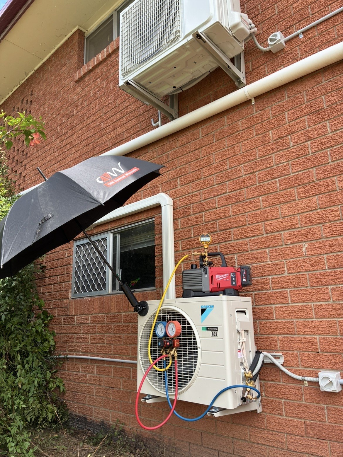 Split system outdoor unit installation in progress at Cornubia home — Amplus van on site