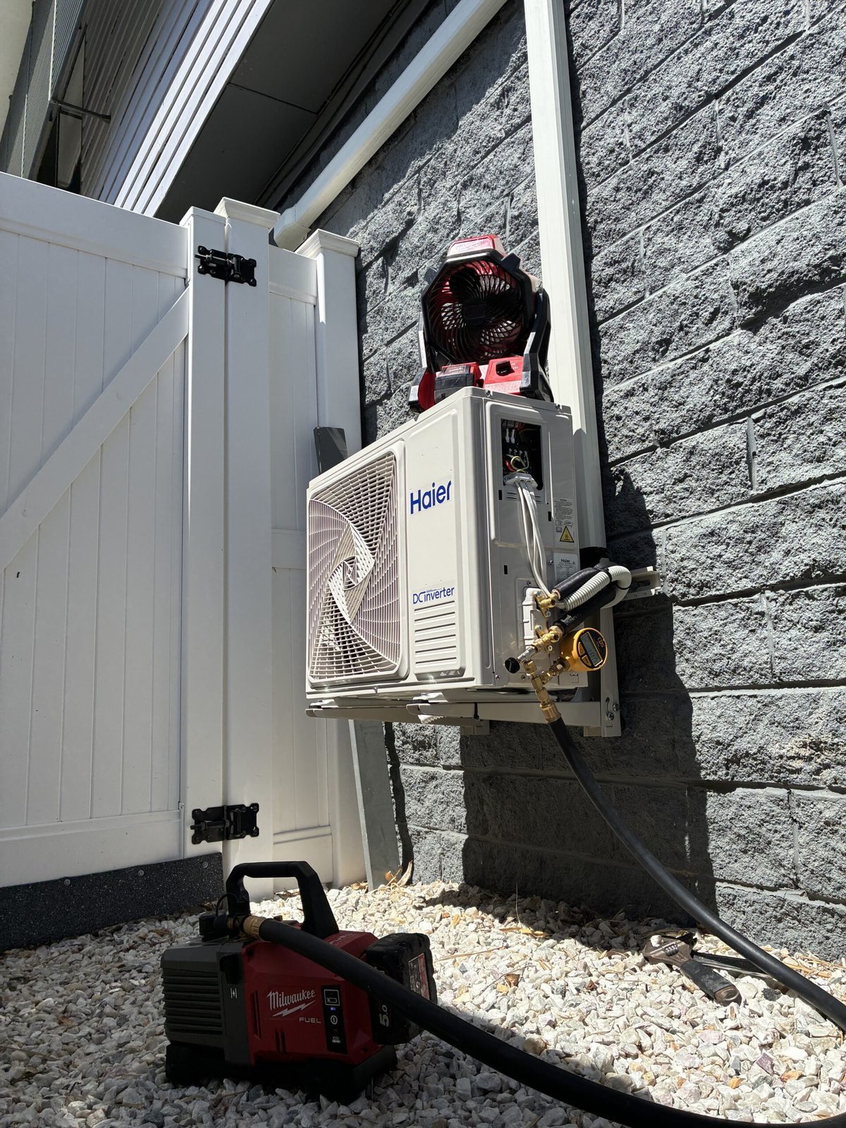Outdoor split system unit wall-mounted installation — Chandler split system by Amplus Electrical and Air