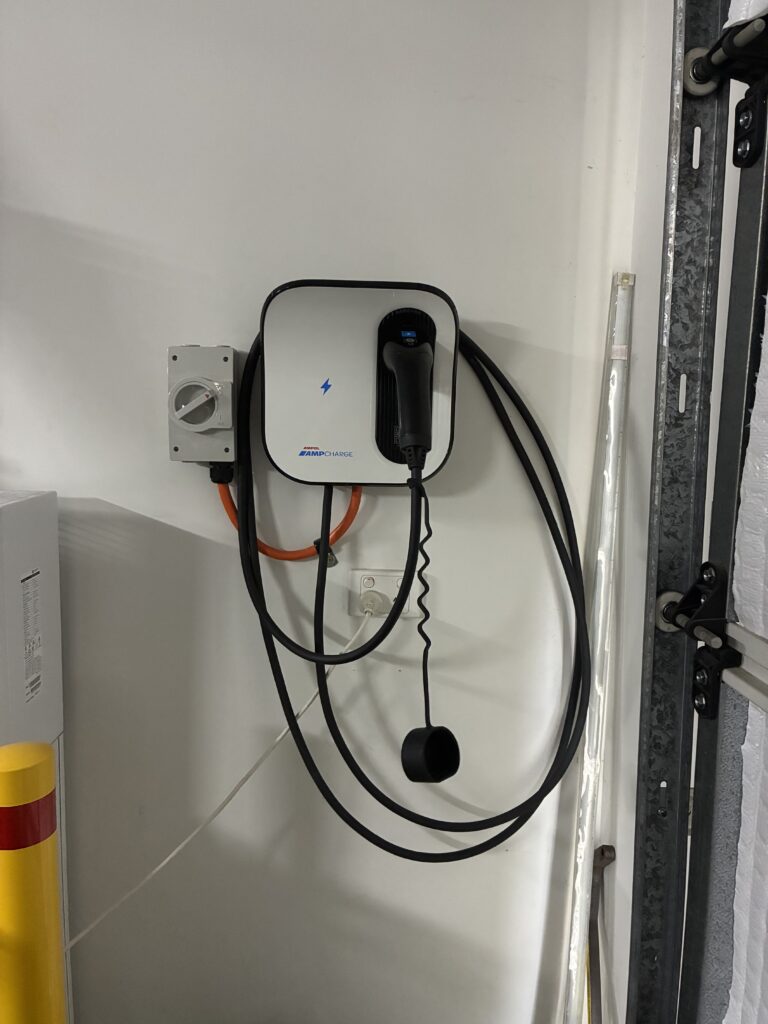 Wall-mounted residential EV charger installed by Amplus Electrical in Brisbane's Redlands — single-phase 7kW setup