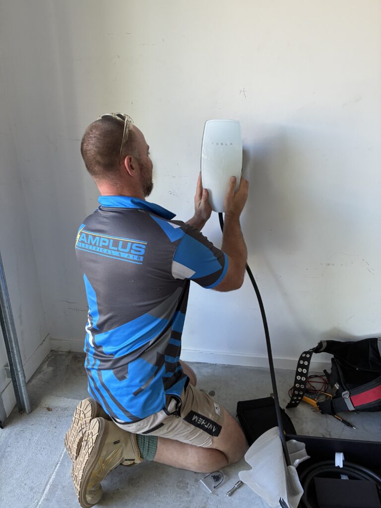 Licensed electrician routing cable from switchboard to EV charger location in Brisbane home