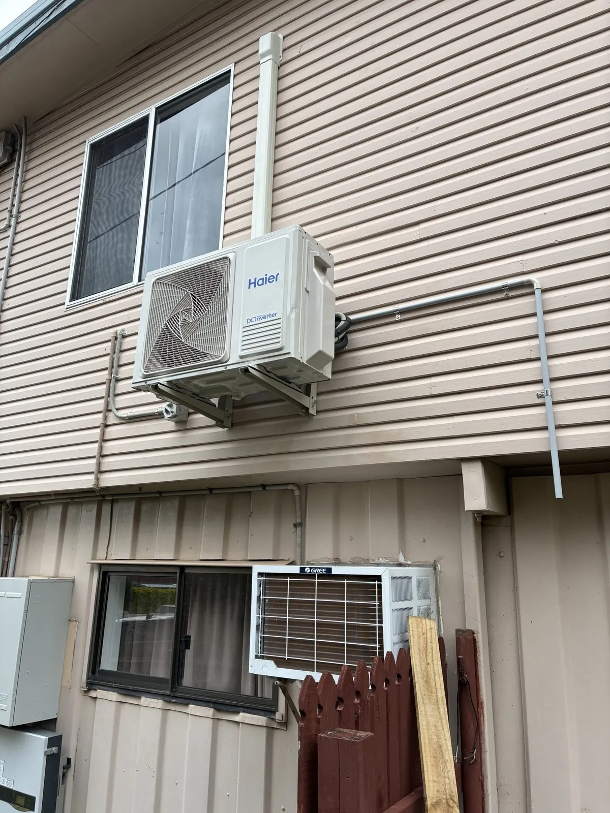 Split system outdoor unit installation in progress at Gumdale home — Amplus van on site