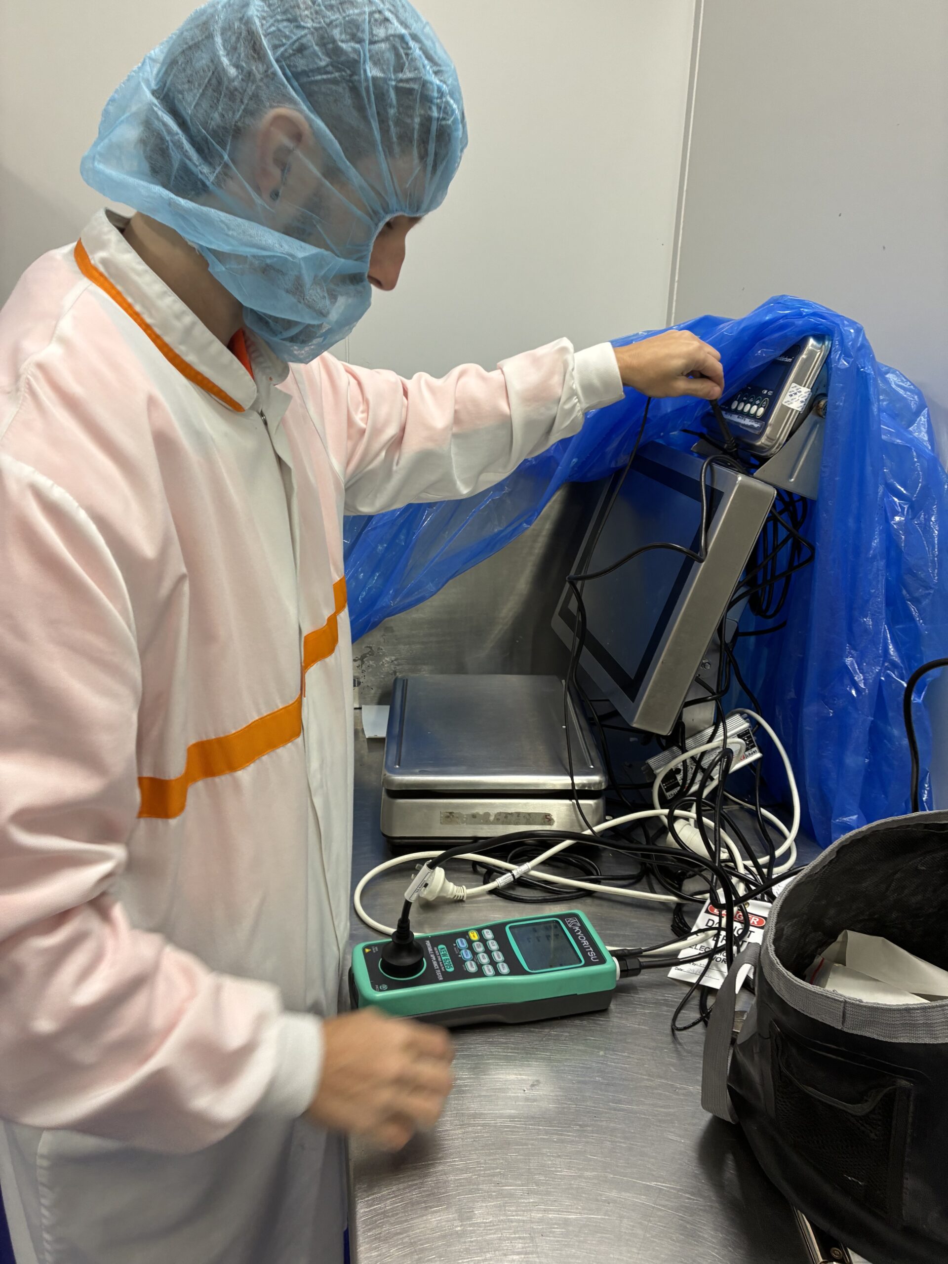 Mitch from Amplus Electrical performing test and tag service on electrical equipment in Brisbane using PAT tester