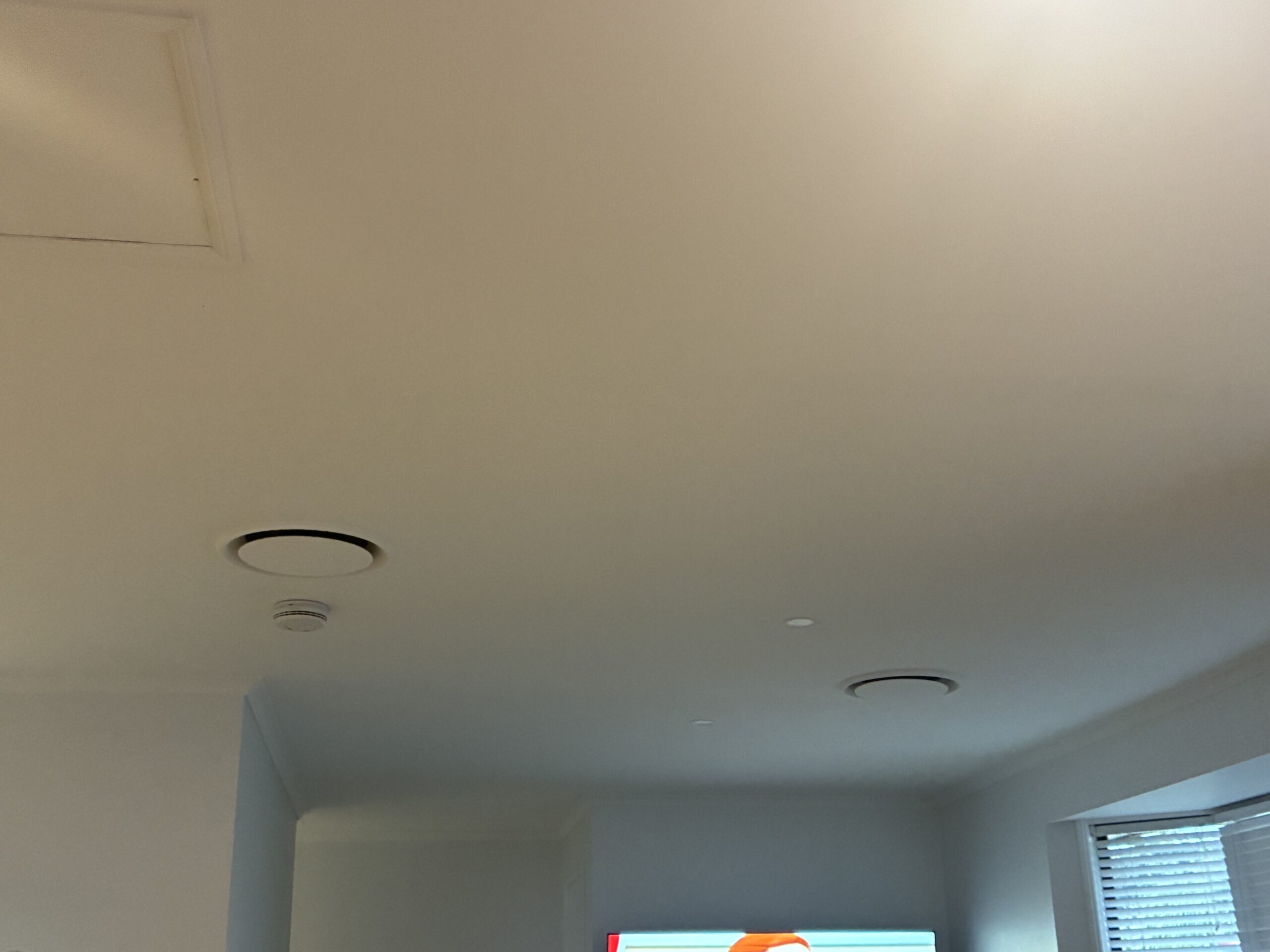 Ducted air conditioning ceiling return air and supply vents in hallway — Capalaba home