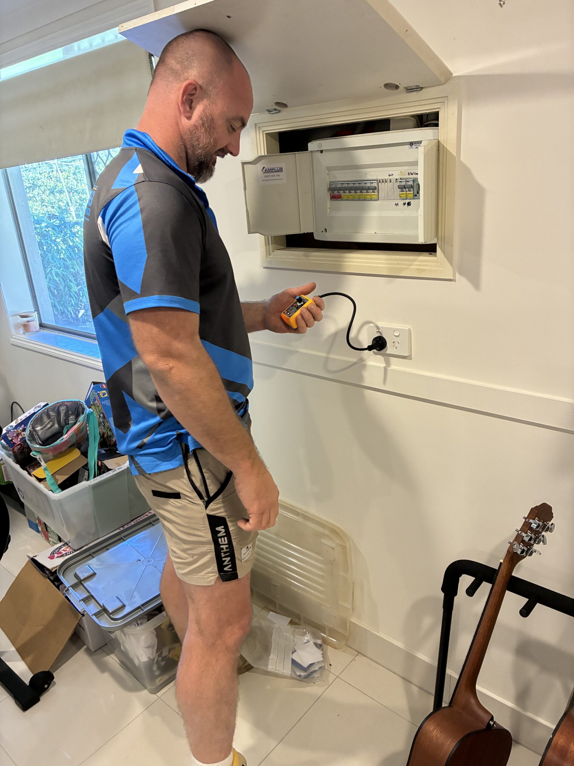 Licensed electrician Aaron Ross performing switchboard upgrade for EV charger Brisbane