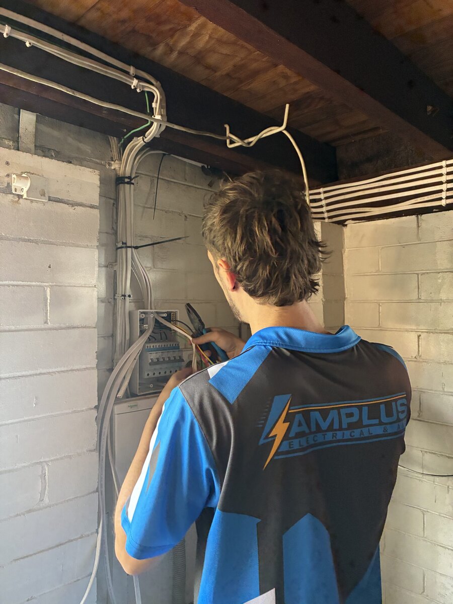 Mitch fitting off a modern switchboard with circuit breakers during a switchboard upgrade in Brisbane