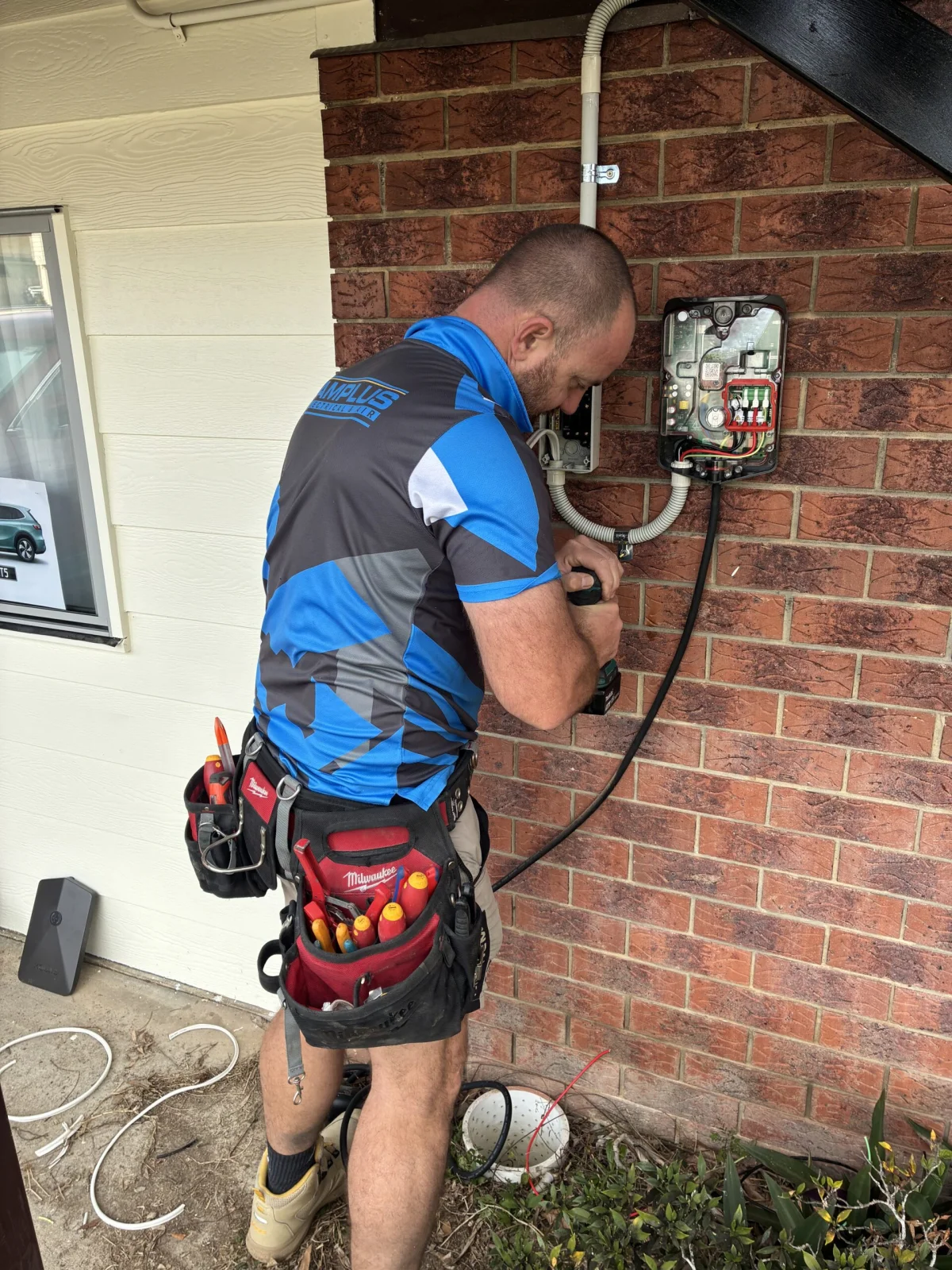 Aaron installing an Evnex EV charger in a Brisbane garage