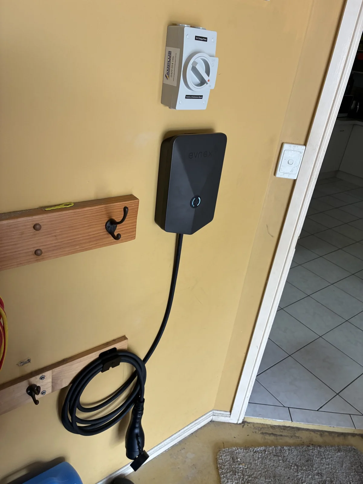 Evnex EV charger fully installed and complete on a garage wall in Brisbane