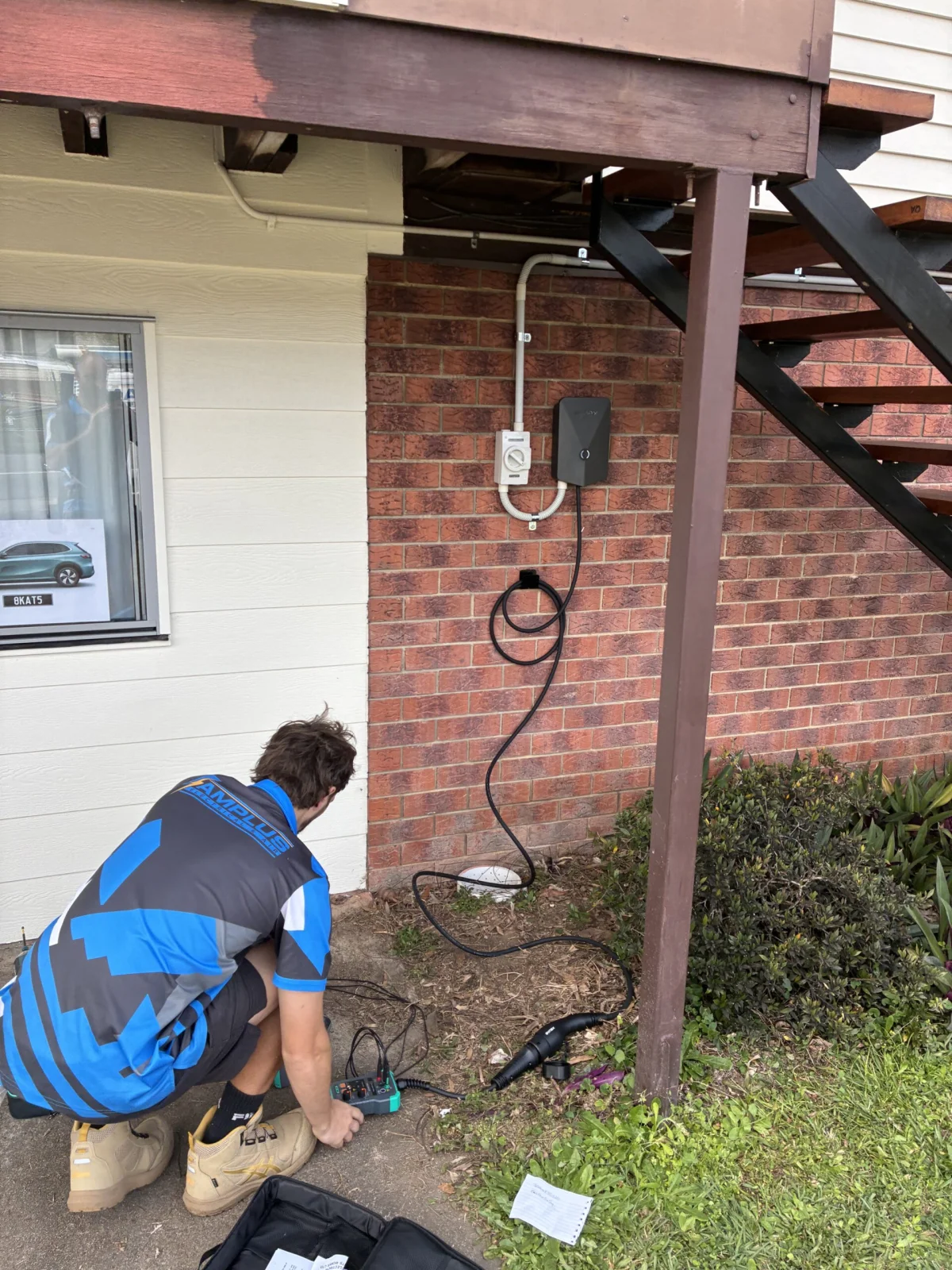 Mitch testing a newly installed Evnex EV charger in a Brisbane garage